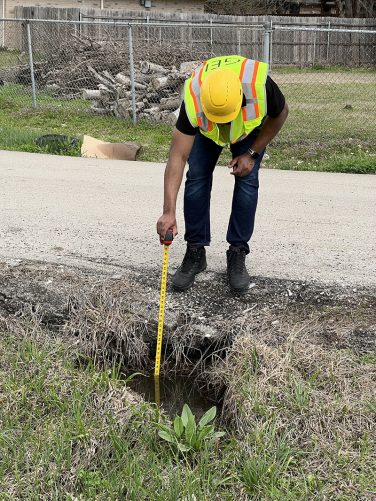 Man measuring drain