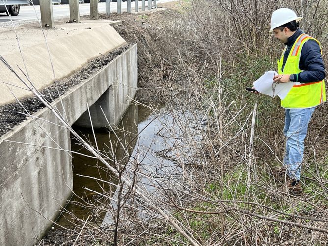 Mam inspecting drainage infrastructure