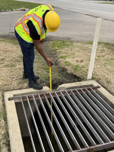 Man measuring drain covers