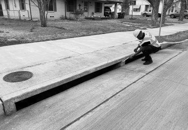 Man measuring at drainage site